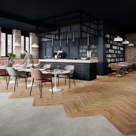 Oak effect flooring laid in a parquet style withing a cafe eating area