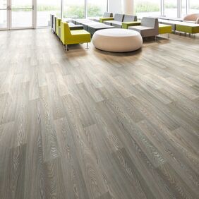 Timber effect flooring laid in a large waiting area with seating