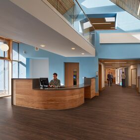 Dark oak wood effect flooring in a reception area 