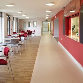 Beige stone effect safety flooring in a cafe dining area