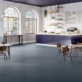 Dark blue safety flooring in a cafe seating area 