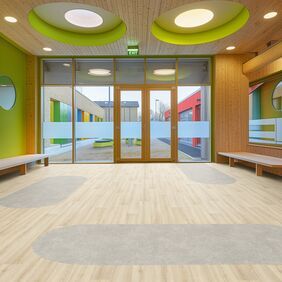 Light coloured ash effect flooring laid in a school waiting area