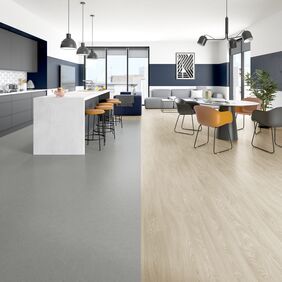 Light wood effect and grey stone effect flooring in a seating and open plan kitchen area 