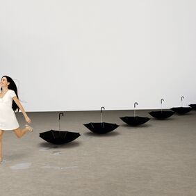 women in a room with umbrellas featuring grey concrete effect flooring 