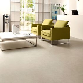 Light stone effect safety flooring in a Modern waiting area with green chairs