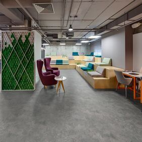 Concrete effect flooring laid in a trendy seating area