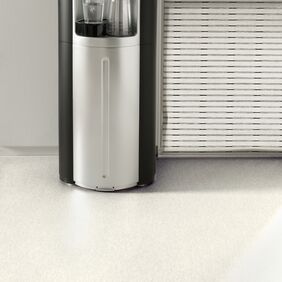 White stone effect flooring in a waiting area with a water cooler