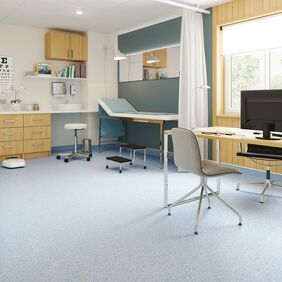 Light stone effect safety flooring in a professional health workers assesment room
