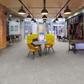 Concrete effect flooring laid in a trendy office space