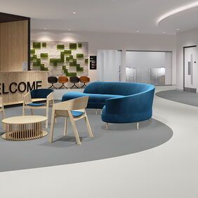 grey flooring in a hospital/doctors reception with blue chairs 
