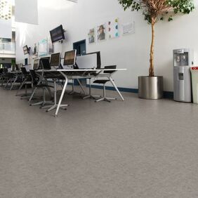 Stone effect safety flooring in a large office space with desk and computers