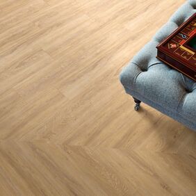 Close up of light wood effect flooring laid in a herringbone design in Sienna Oak