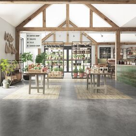 Grey stone effect flooring and light wood effect flooring creating zonal spaces in a garden centre