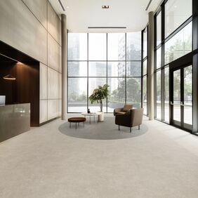 Light coloured cement flooring laid in a modern office waiting area
