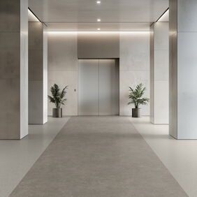 Light grey coloured flooring laid in a lift vestibule 