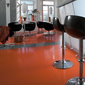 Cafe with seating and warm red coloured flooring