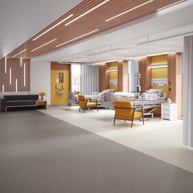 Neutral colour safety flooring in a hospital ward with beds and seats