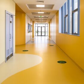 School corridor with two shades of yellow flooring