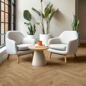 Oak effect parquet flooring laid in a seating area with white chairs and large plants