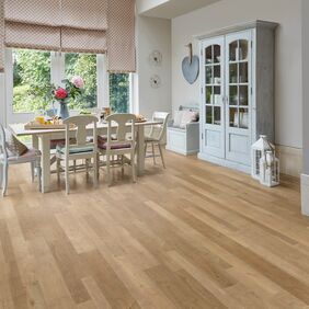 Modern family dining area with white wood table and chairs feturing a natural timber wood effect flooring in Salvaged Timber 