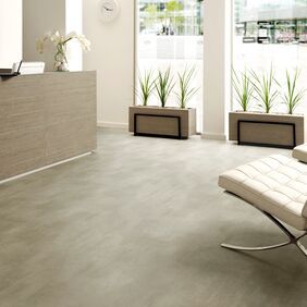 Light concrete effect flooring in a modern waiting area