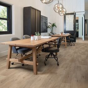 Oak effect flooring laid in a room with tables and chairs