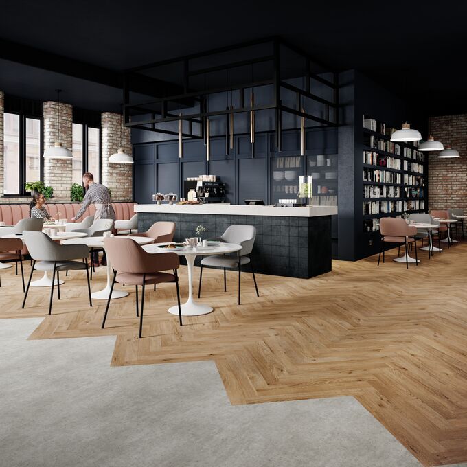 Oak effect flooring laid in a parquet style withing a cafe eating area