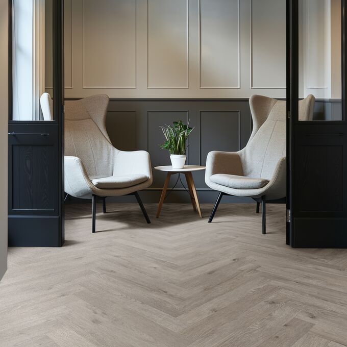Oak effect flooring laid in a parquet style in a seating area