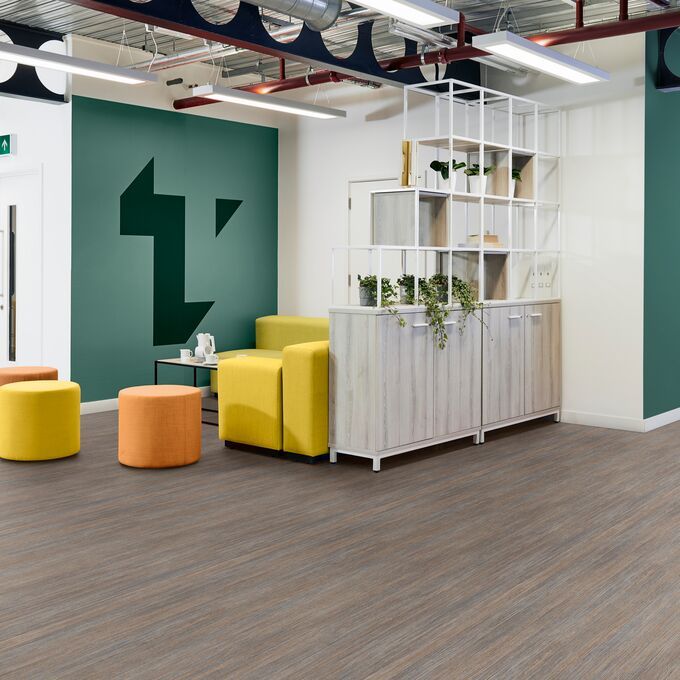 Dark coloured flooring laid in a modern office space