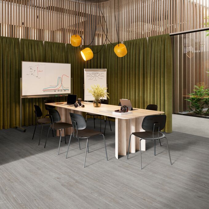 Grey coloured oak effect flooring laid in a meeting room space