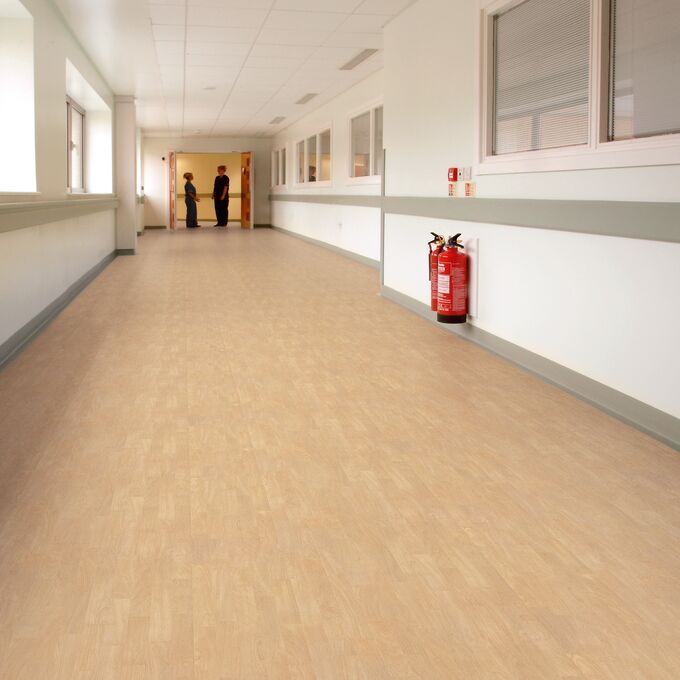 Light oak wood effect flooring in a large hospital corrdior 