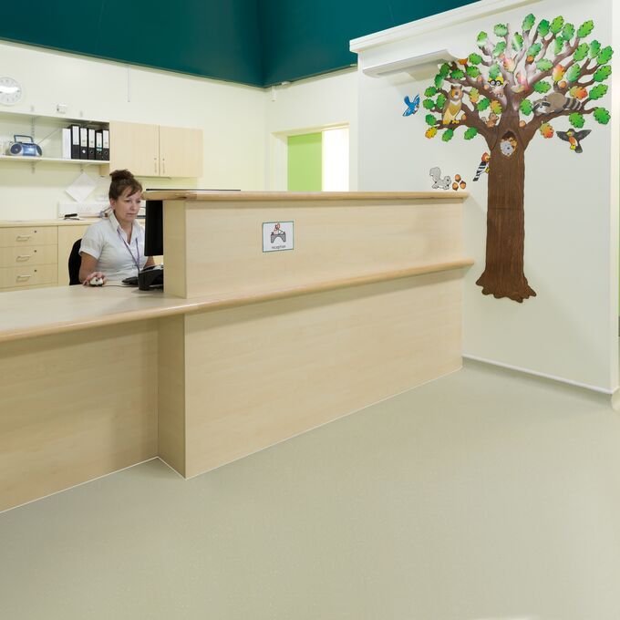 Neutral coloured flooring in a hospital ward nursing station