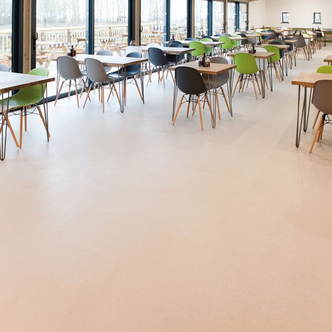 Neutral coloured safety flooring in a cafe seating area