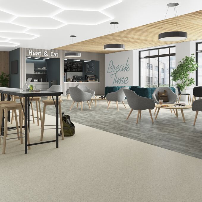 Light stone and silver oak wood effect flooring in a break time area 