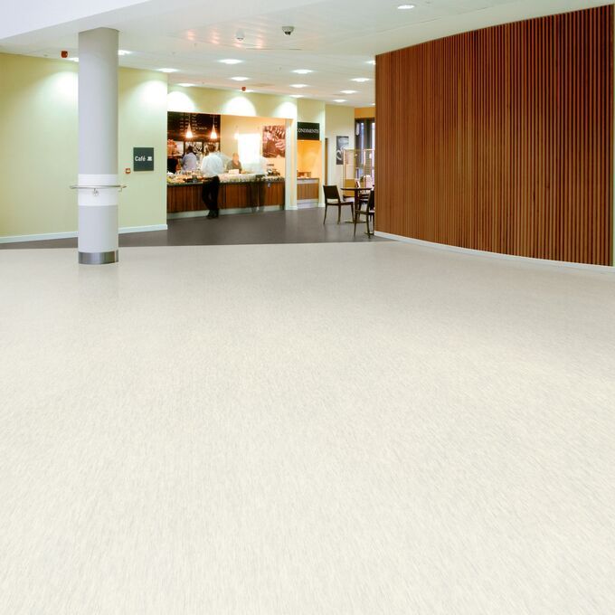 Light stone effect flooring in a canteen 