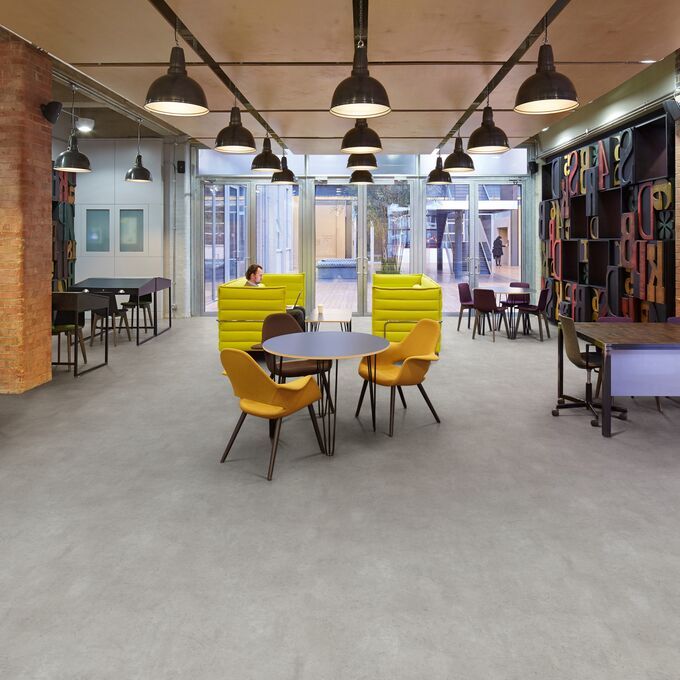 Concrete effect flooring laid in a trendy office space