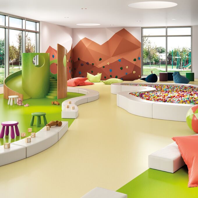 Children's playroom with a ball pool and green slide