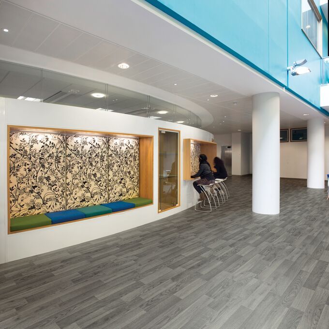 Silver oak wood effect flooring in a highschool breakout area
