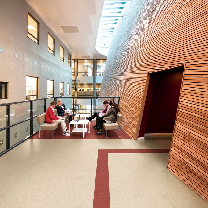 Light stone effect flooring in a seating area with decorative wood slat walls 