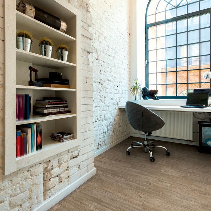 Rustic light brown wood effect flooring in a office space