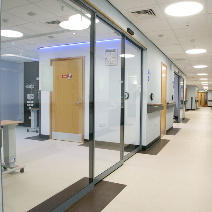 Light stone effect flooring in a hospital corridor