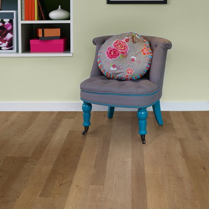 Reading area with a grey cushioned seat featuring a light wood timber effect flooring in Salvaged Timber 