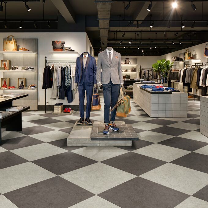 Light grey and dark grey chequerboard laid pattern flooring in a retail store 