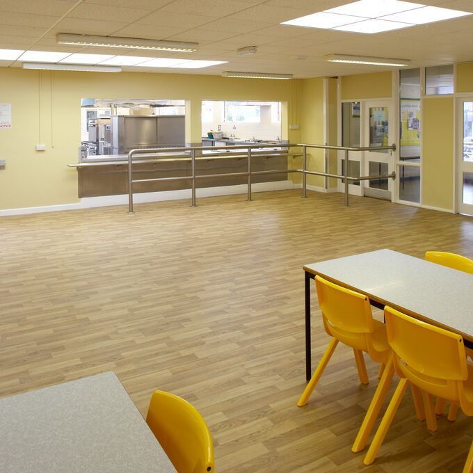 Rustic oak wood effect flooring in a school canteen